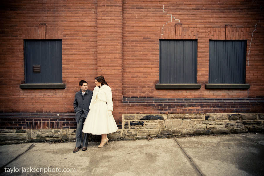 bride and groom by wall Waterloo Ontario